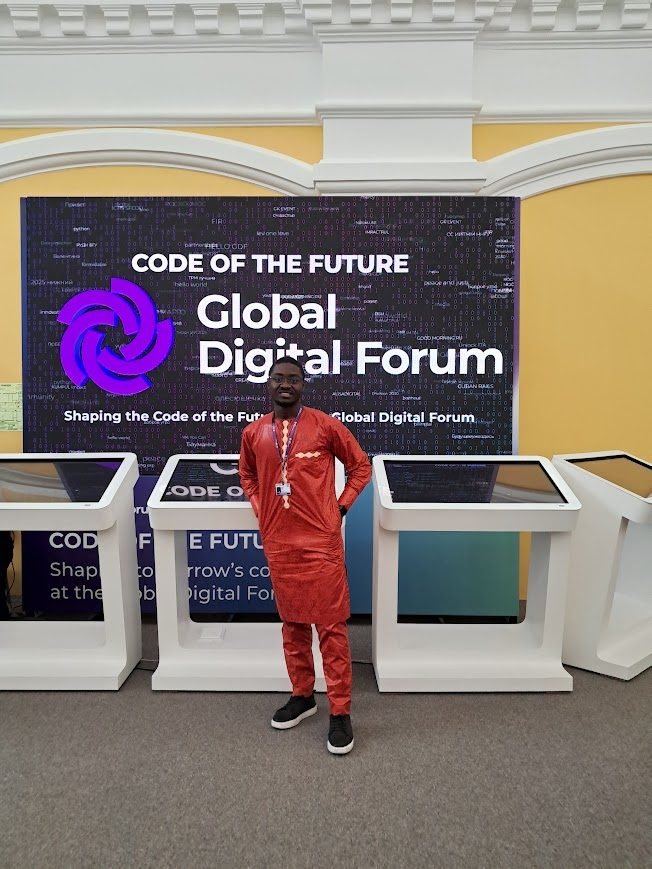 Dimitri FONE in traditional Cameroonian attire at the Code of the Future exhibition, Global Digital Forum 2025